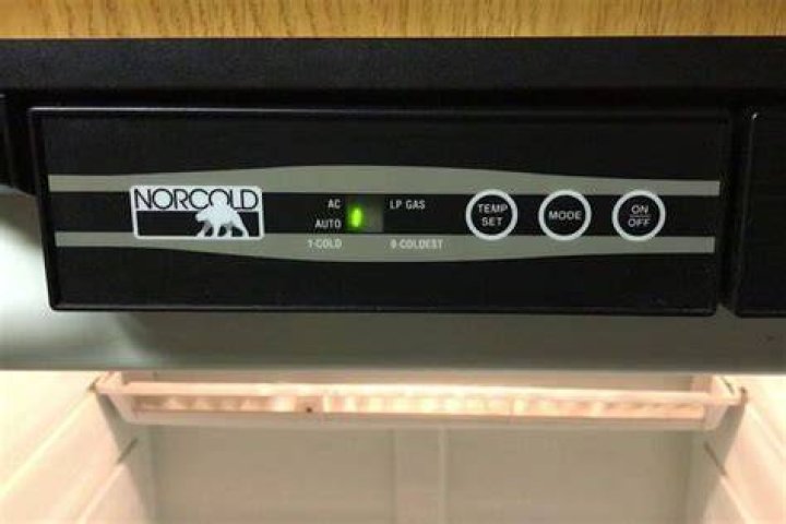 How do I lower the temperature on my Norcold RV refrigerator?
